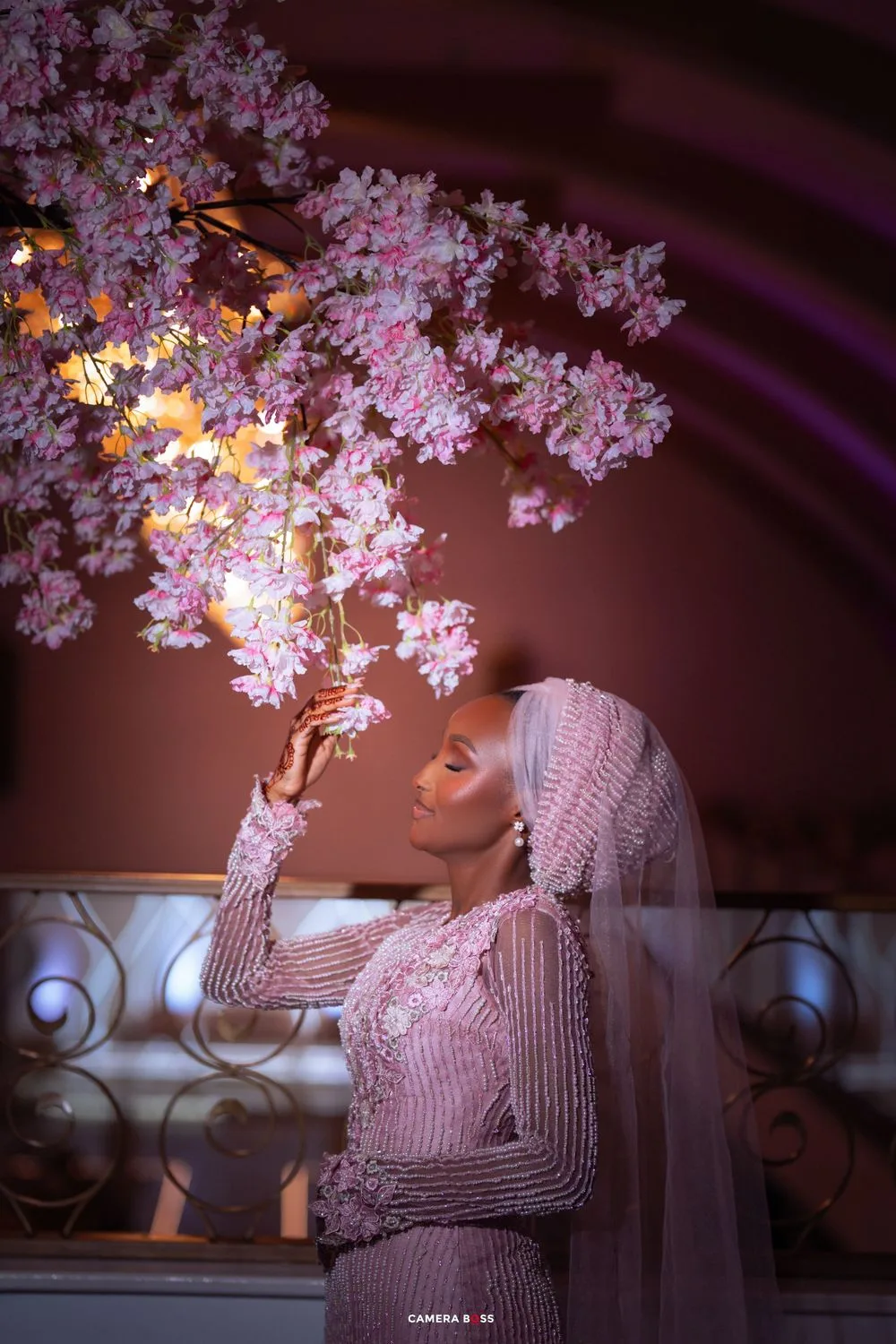 Artistic photo series showing a person in pearls and veil near pink cherry blossoms at night with dramatic lighting effects.
