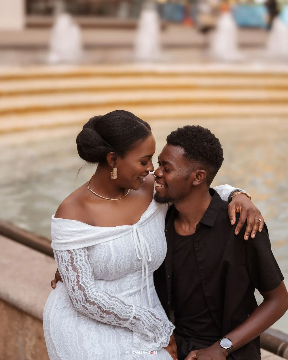 Romantic couple in white and black outfits share intimate moments in a series of outdoor portrait photos.