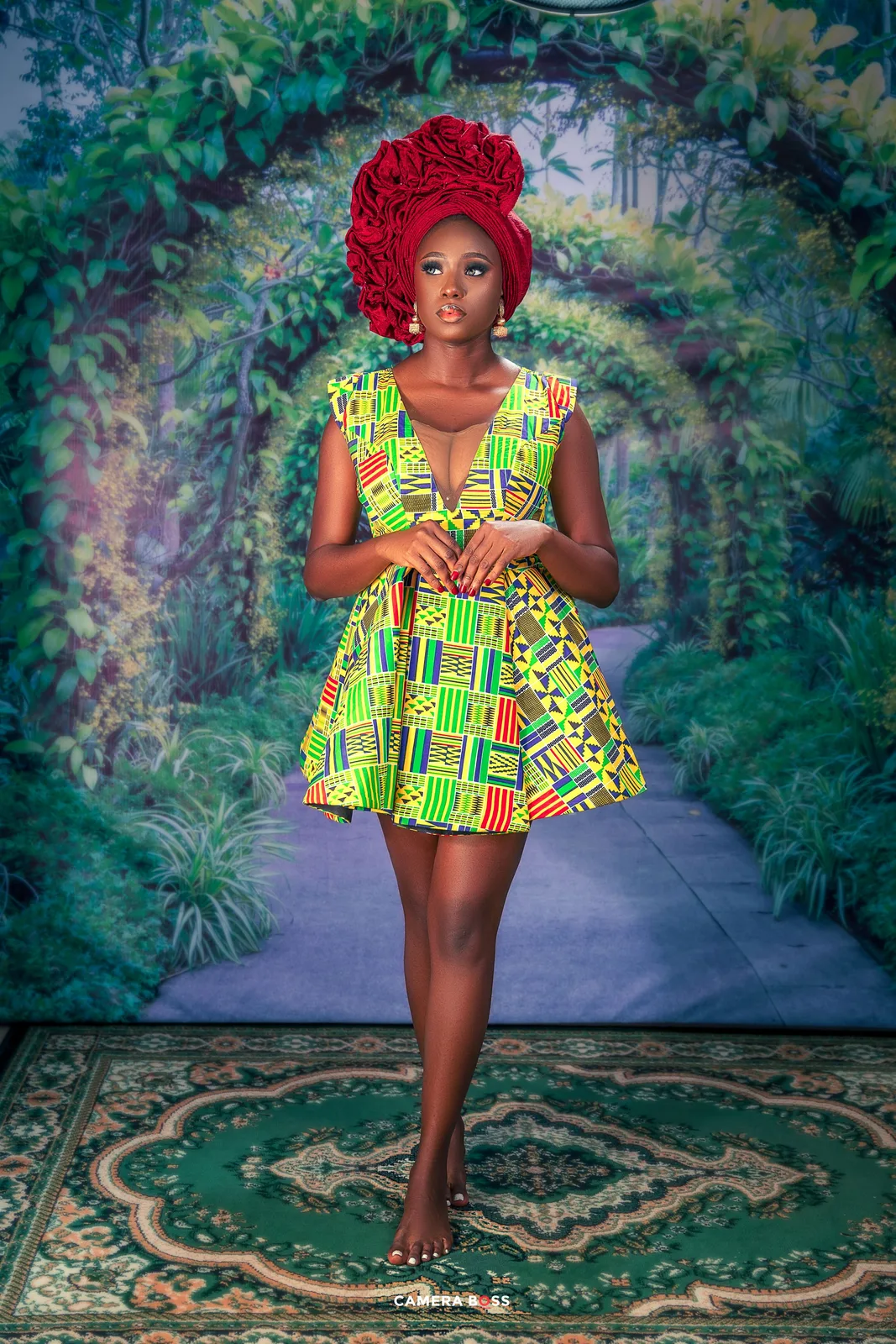 Vibrant portrait series in African print dress against lush garden backdrop.