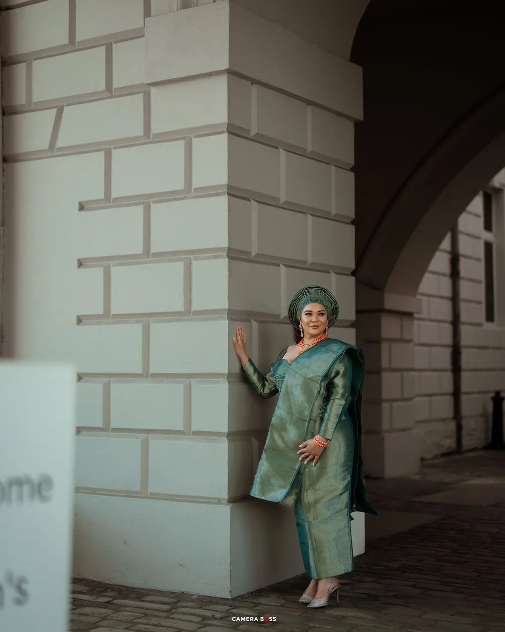 Artistic photo sequence showing a figure in teal clothing performing expressive movements against white pillars.