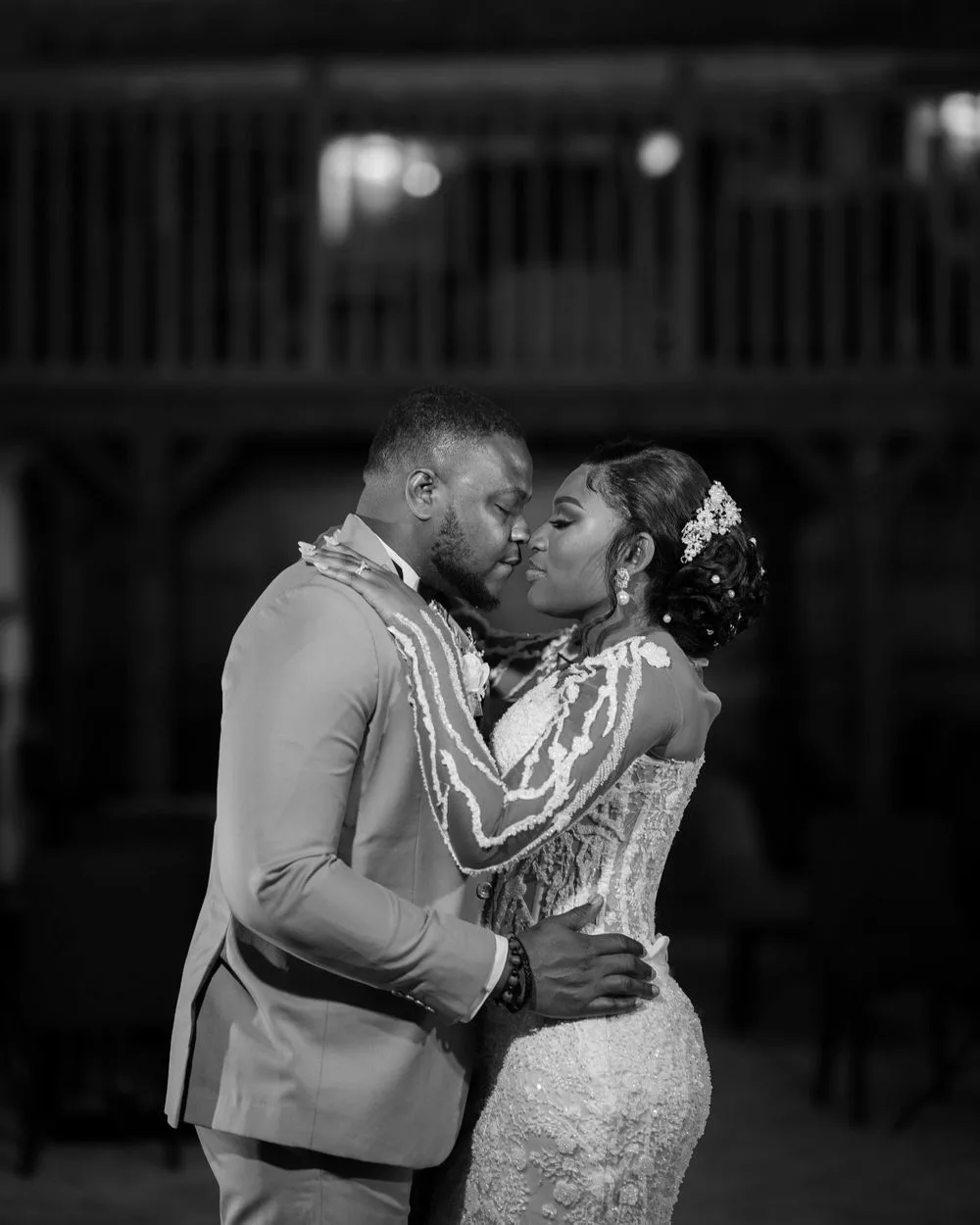 A romantic black and white photo captures a tender moment during a wedding first dance.