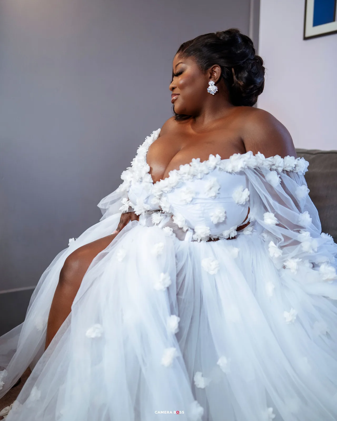 A bride in a flowing white tulle gown with floral details poses gracefully in a series of elegant portraits.