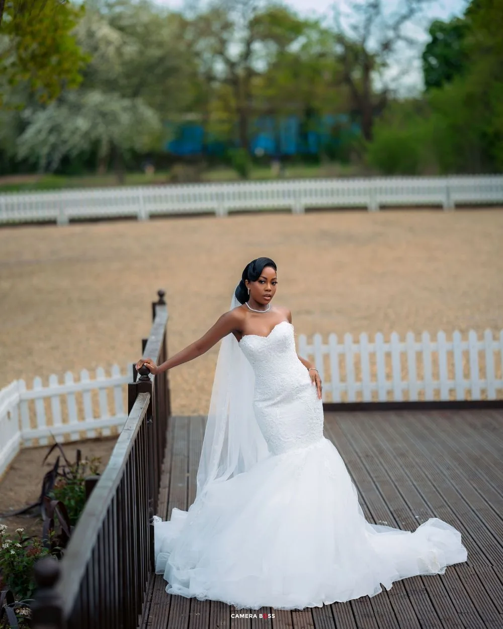 Sequence of photos showing a bride in a flowing white wedding dress posing on a wooden deck with a white picket fence.