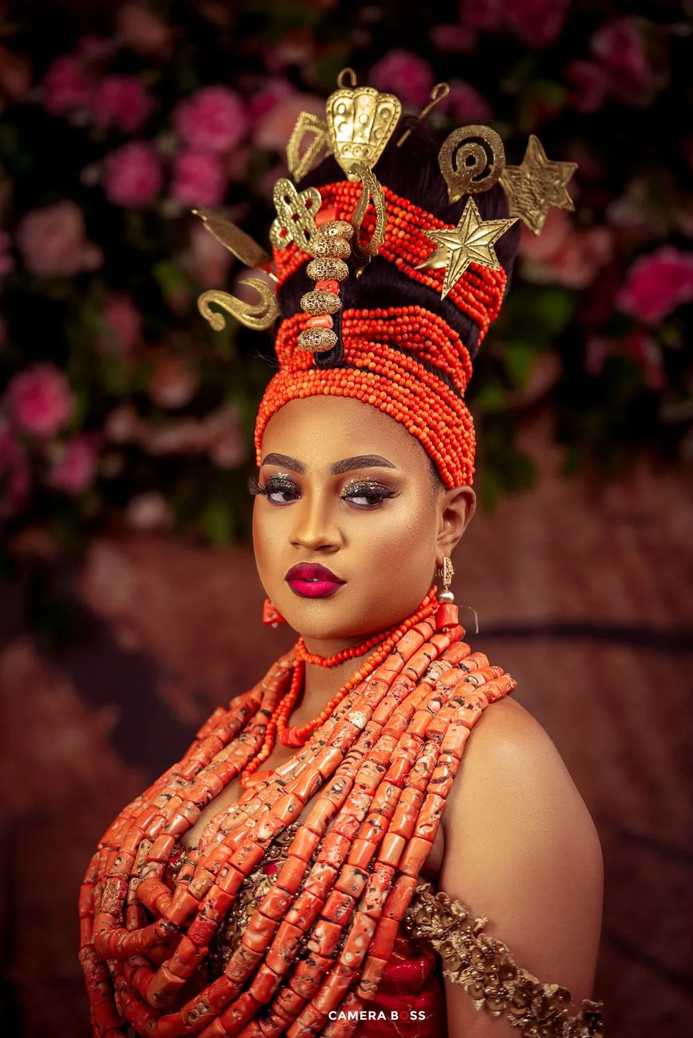 Traditional Nigerian bridal portrait featuring ornate coral beaded crown and necklaces.