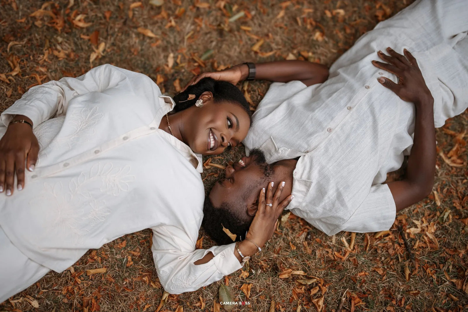 A figure in white clothing lies peacefully on autumn leaves in an artistic photo series.