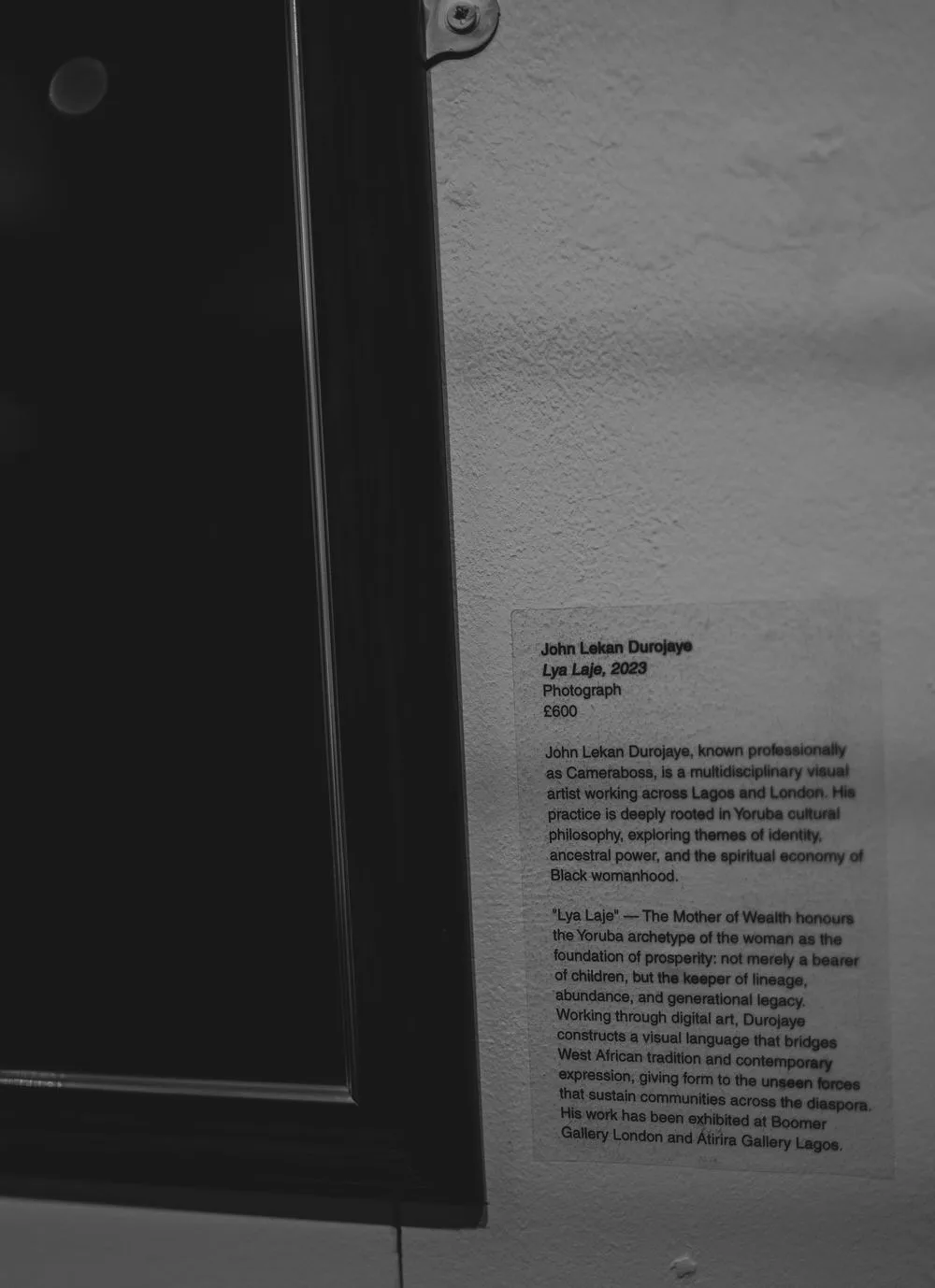 Museum wall label for John Lakan Dunjoye's 2025 photography work Lye Laje displayed in a gallery.