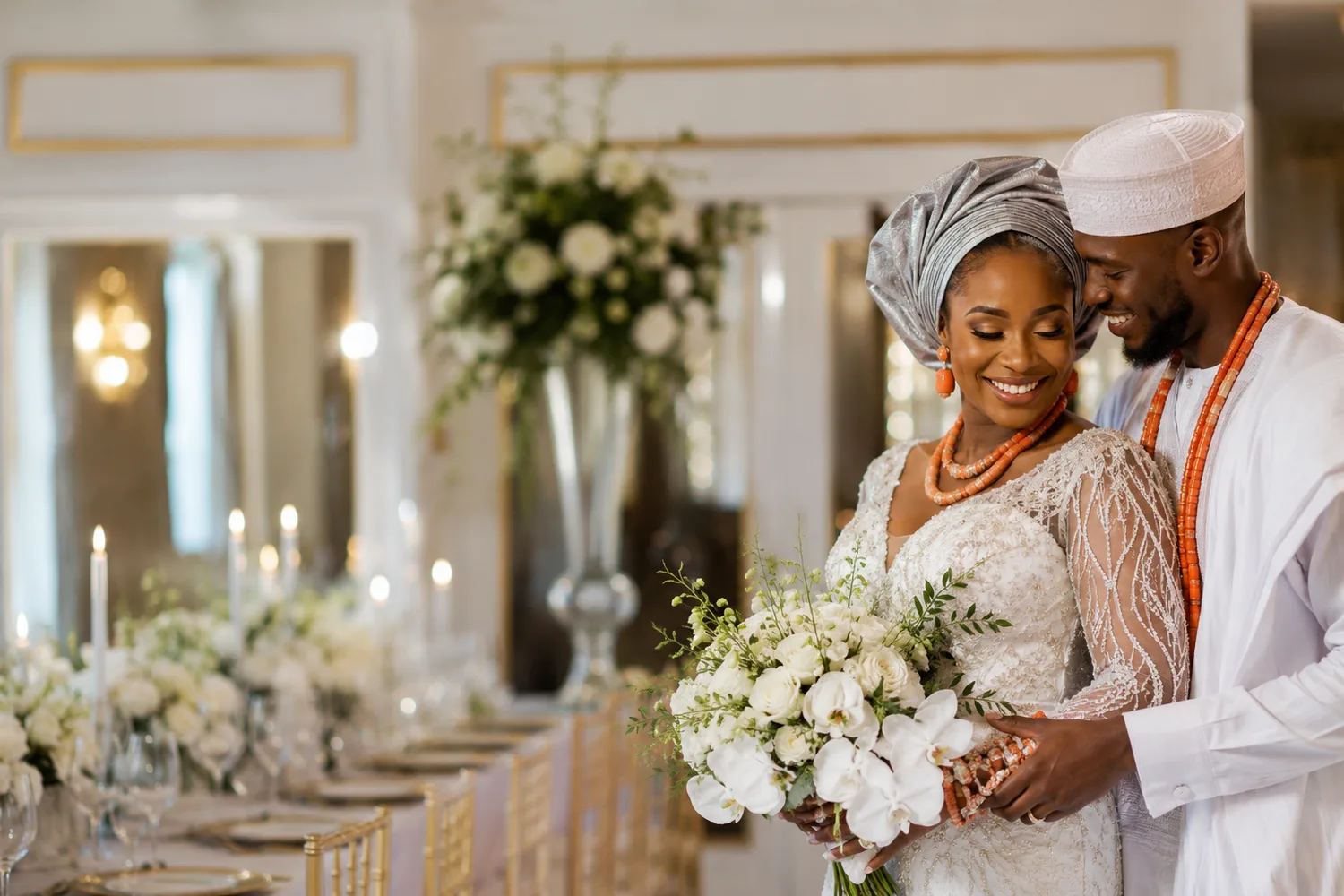 Bride and groom share a romantic moment in front of an ornate fountain, bride holding a bouquet in a white gown.